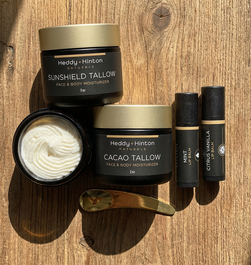Picture of Beef Tallow Moisturizers and Lip Balms and a Wooden Table